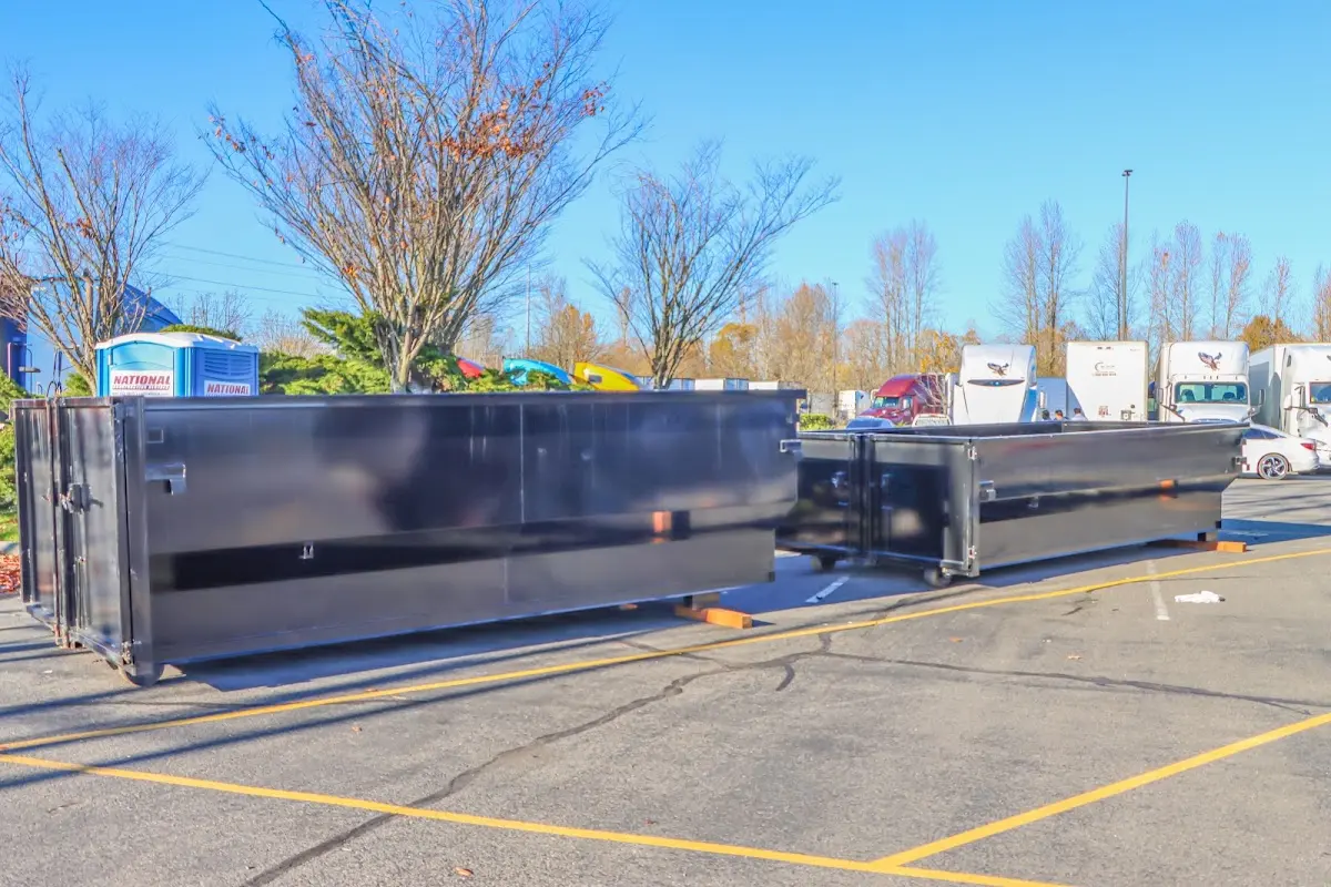 Professional dumpster rental service with roll-off container on residential driveway in Lake in the Hills